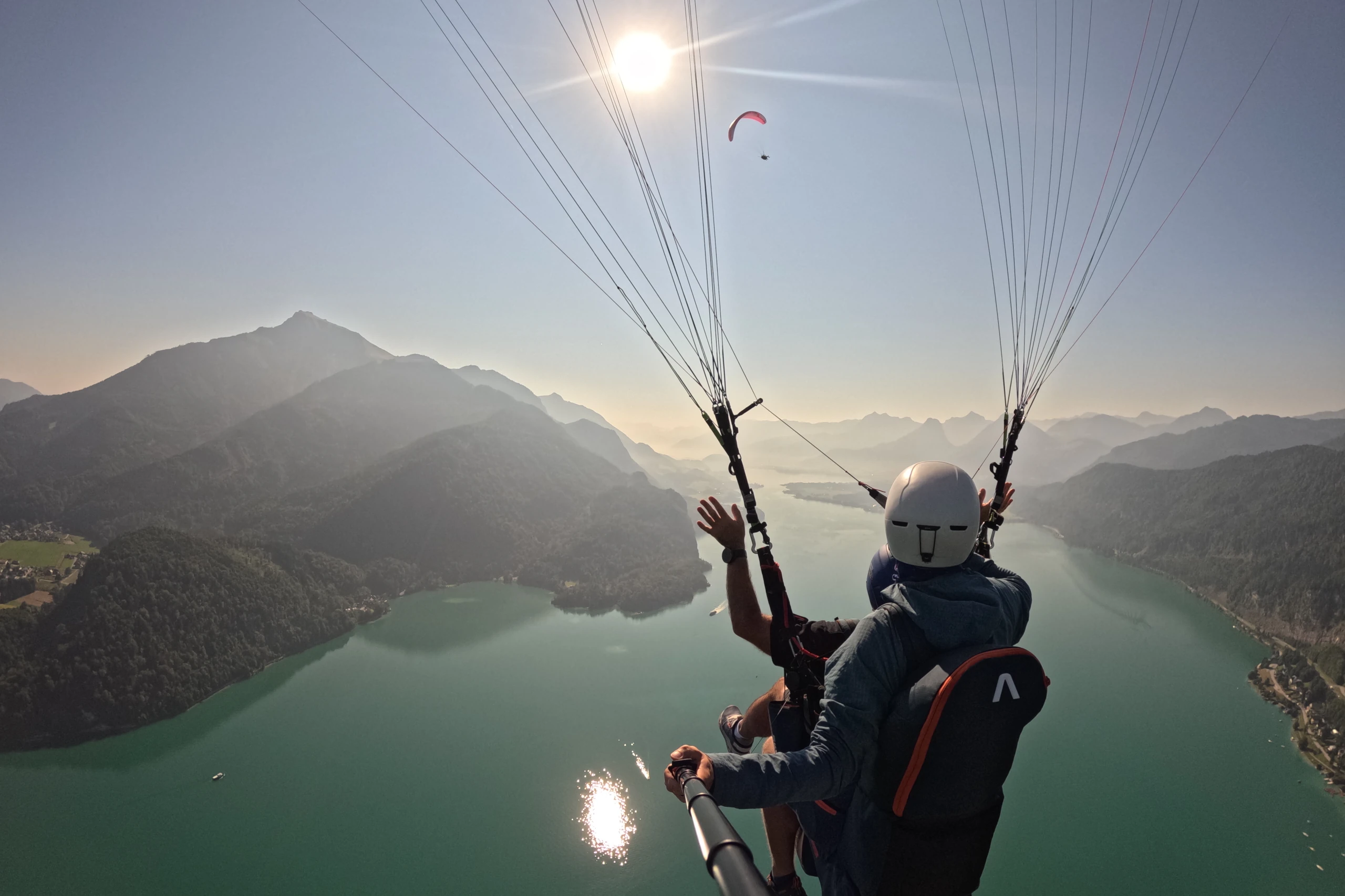 Morning tandem flight over Lake Wolfgangsee - view from behind of pilot and passenger in the Salzkammergut region